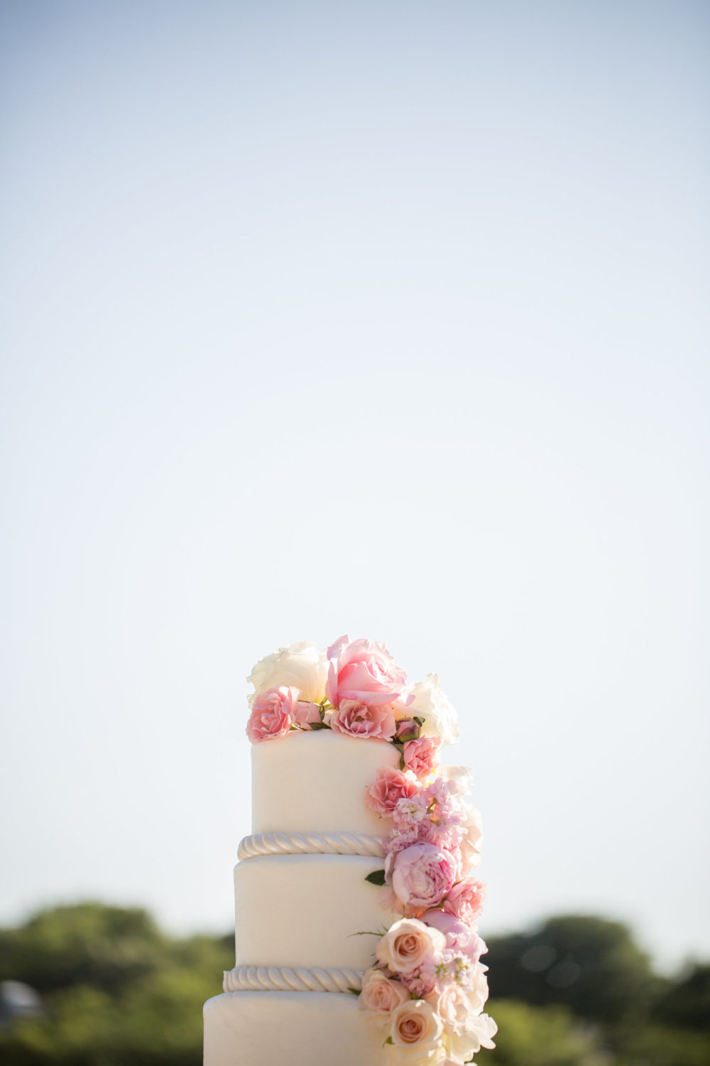 custom wedding cake with cascading blush florals