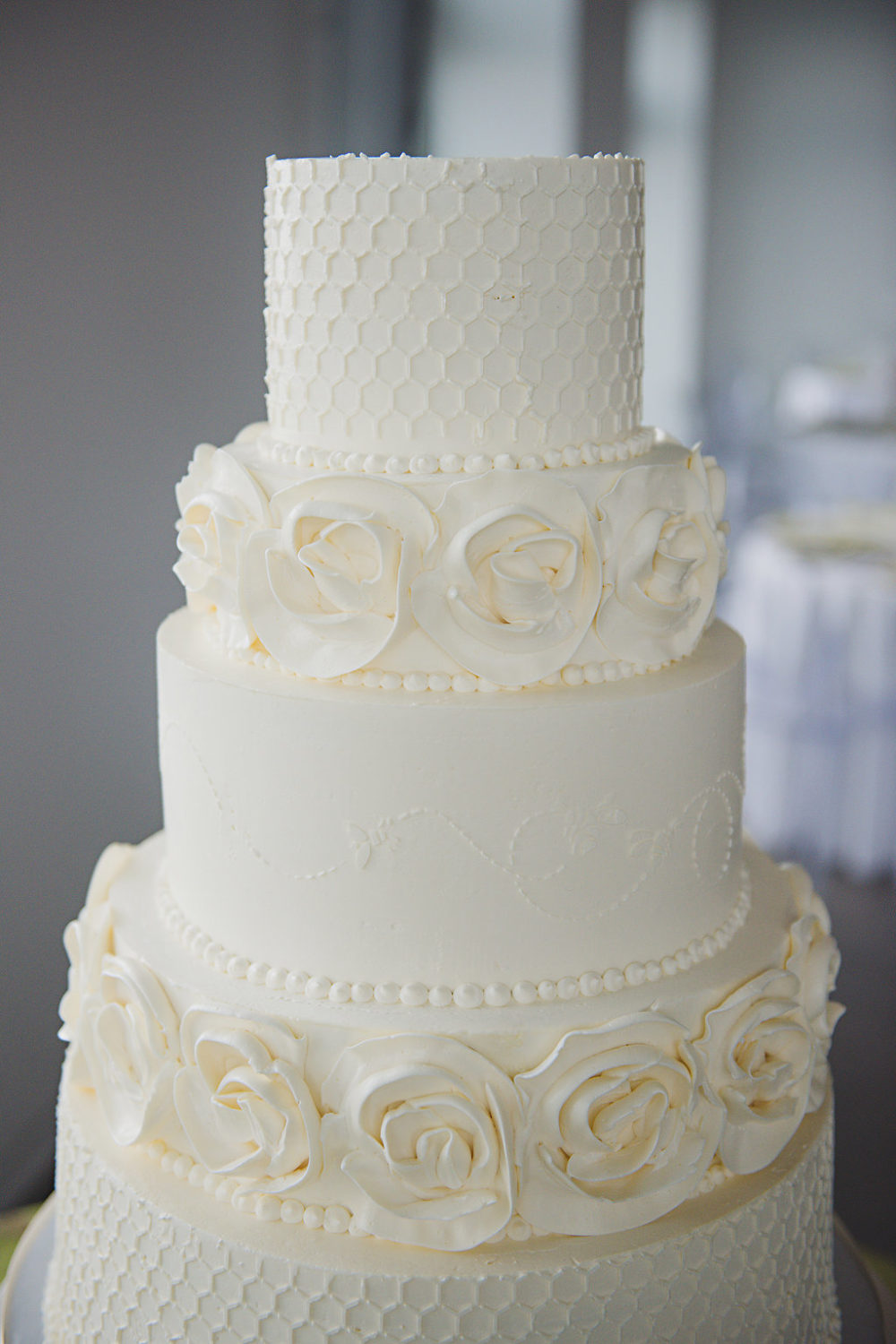 white wedding cake, honey combs and roses